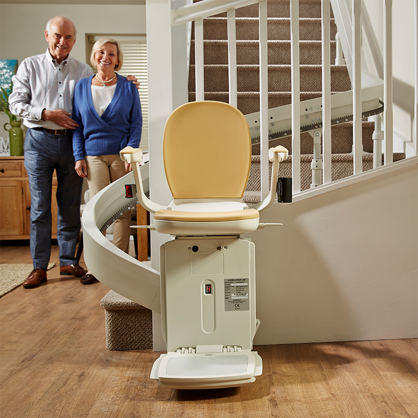 Stairlift with man and woman behind it